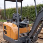 MX-10 mini excavator operator station with joystick controls and travel levers