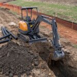 MX-25 mini excavator digging a deep utility trench for drainage pipe